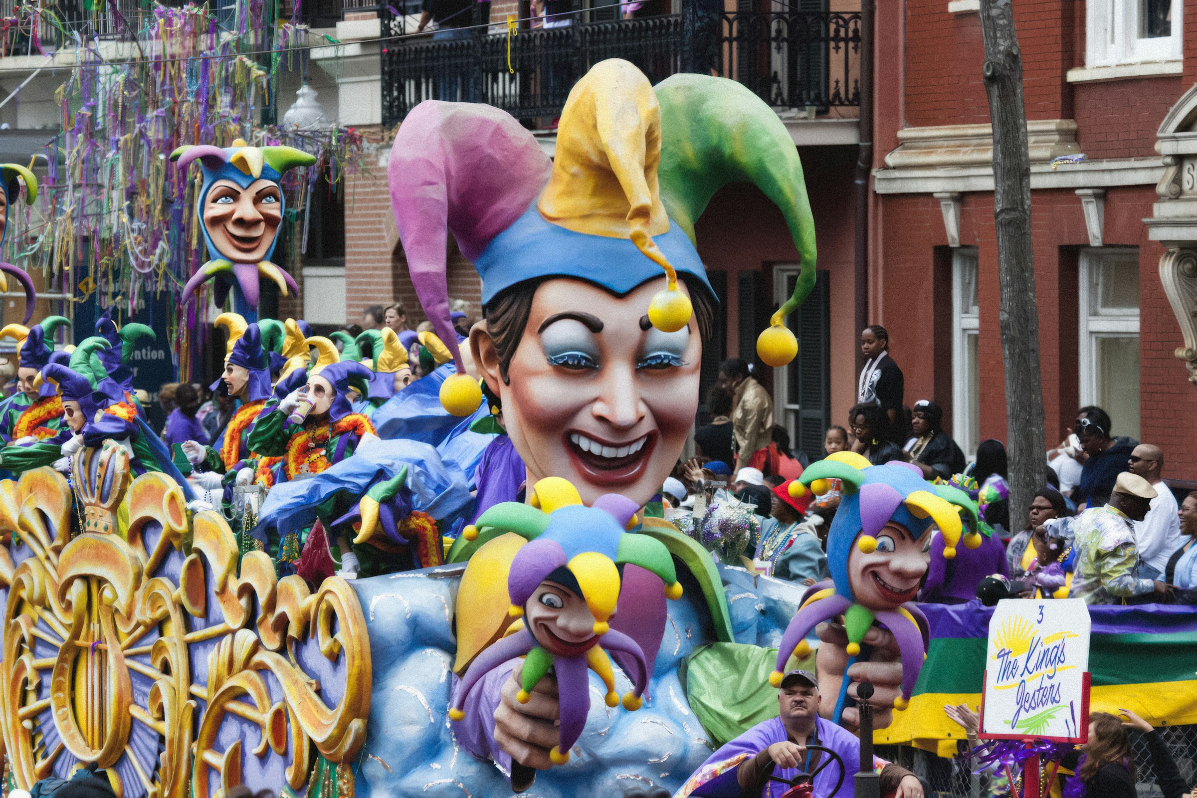 Colorful Mardi Gras parade float rolling through New Orleans, Louisiana, surrounded by crowds