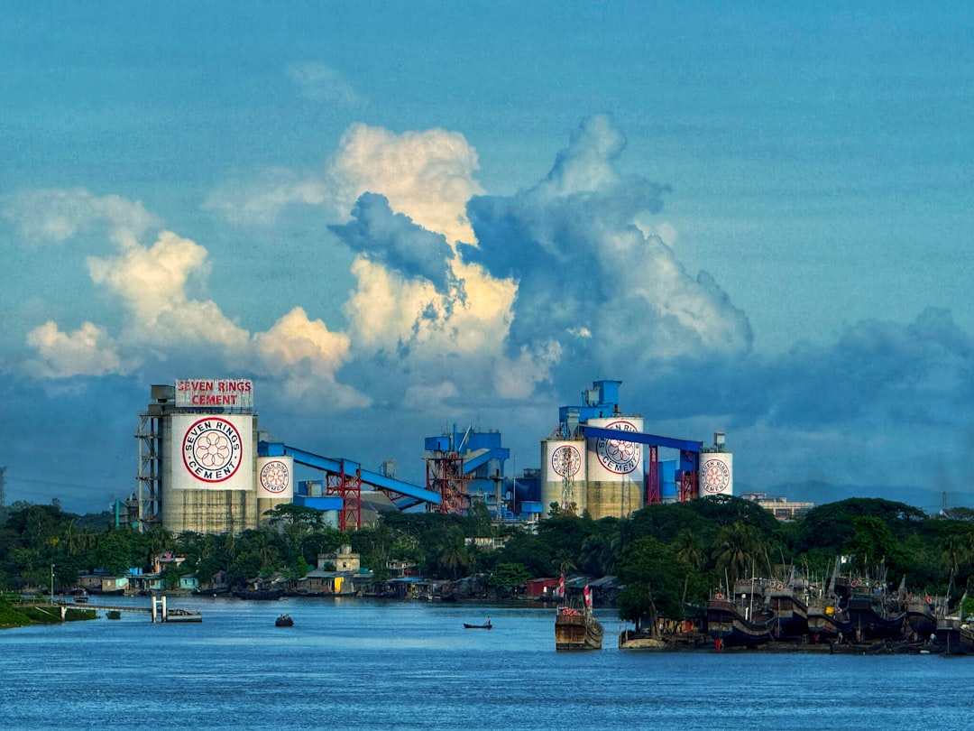 Industrial complex by the river under a cloudy sky