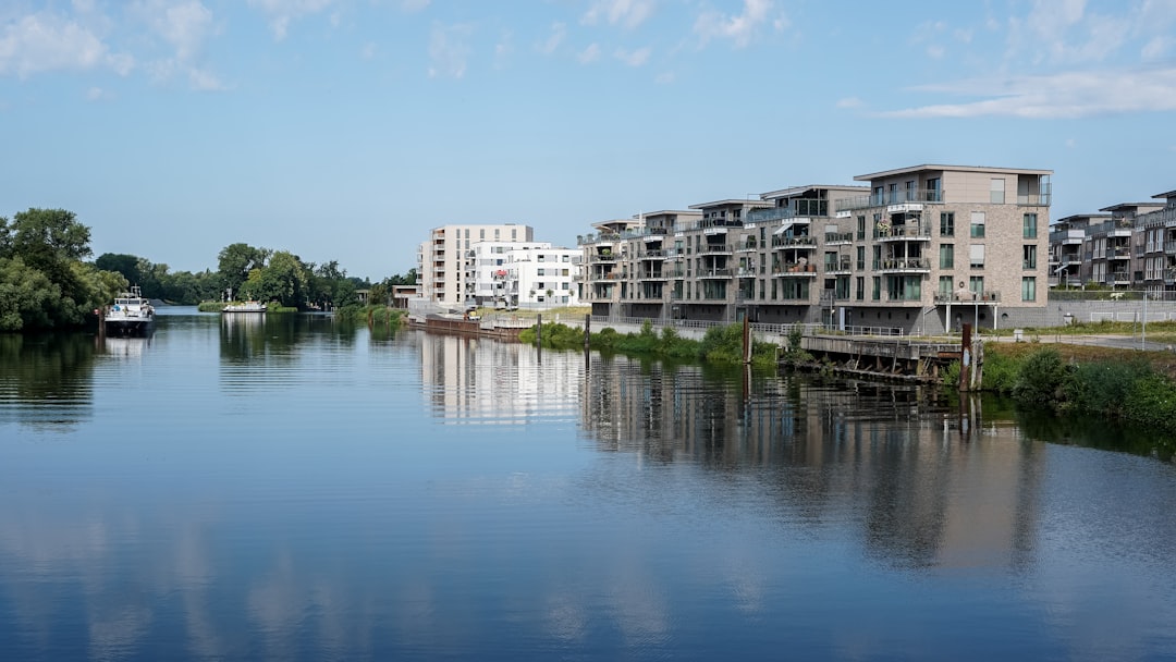 Waterfront view of modern apartments reflecting in a river.