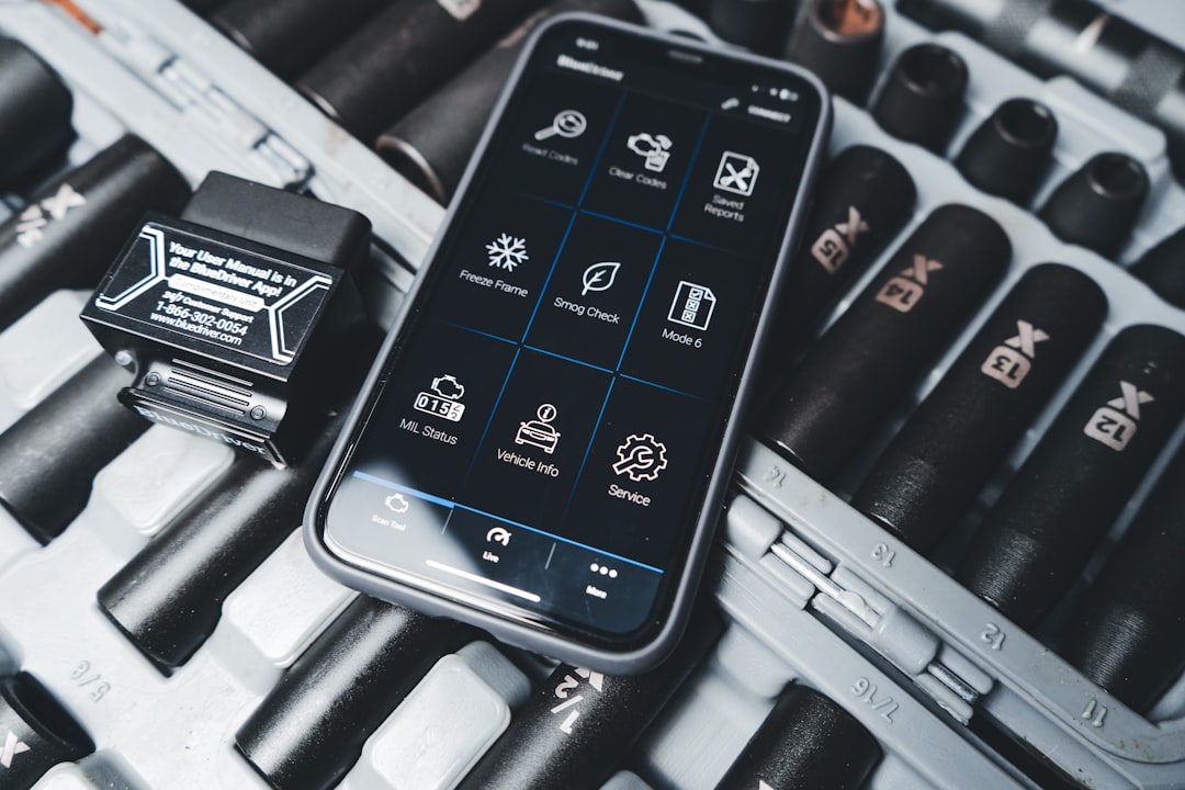 a cell phone sitting on top of a keyboard
