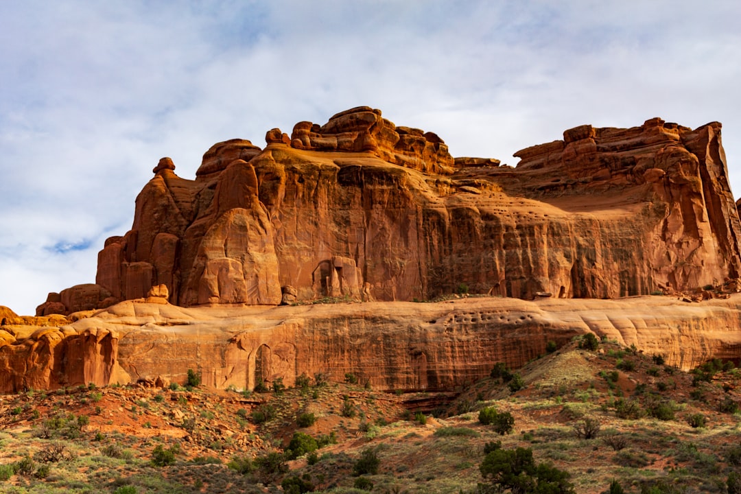 A large rock formation in the middle of a desert