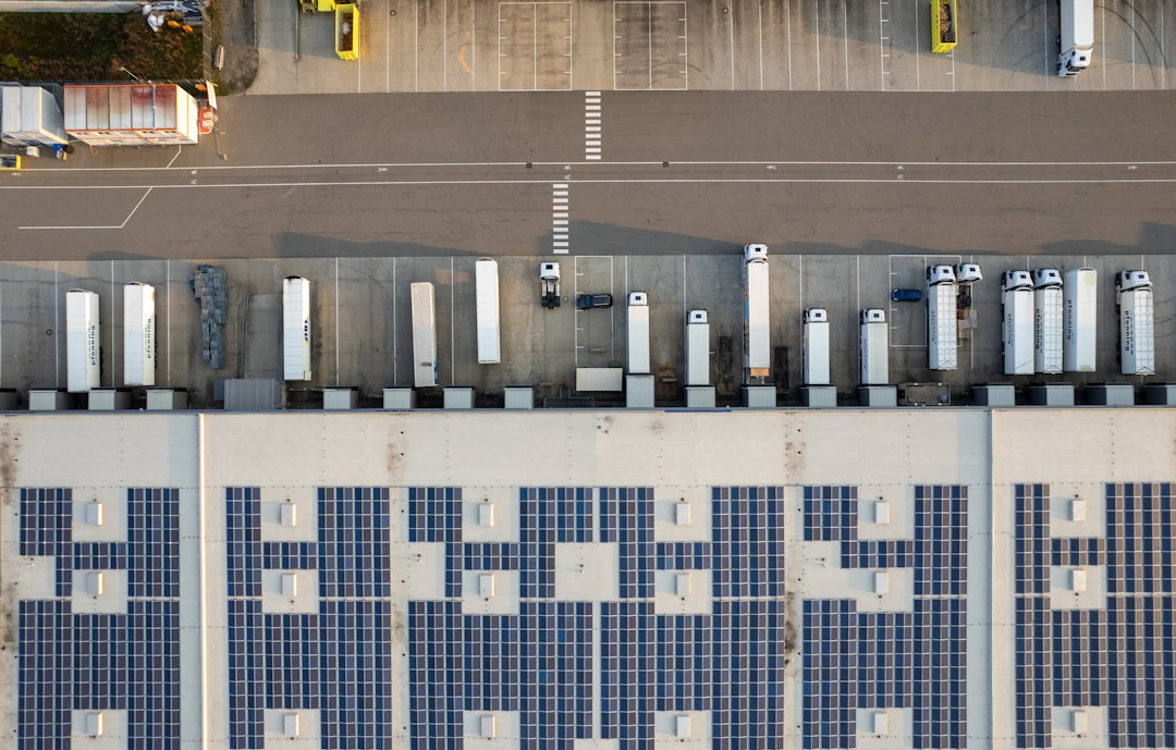 An aerial view of a parking lot with cars