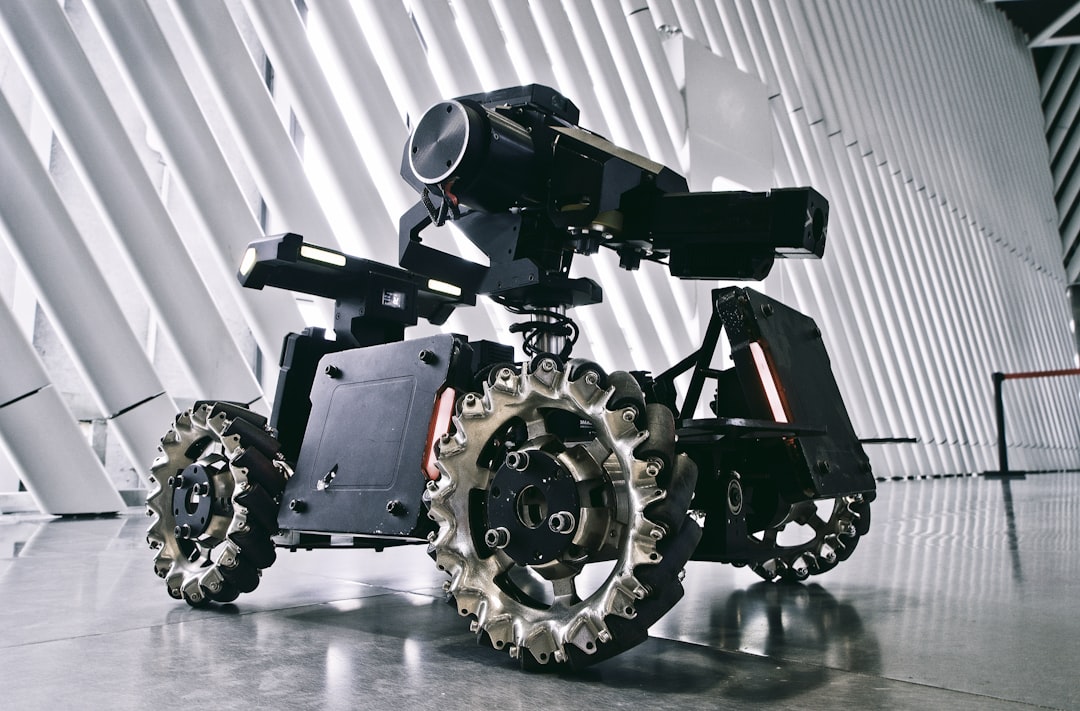 A black and white photo of a camera on wheels