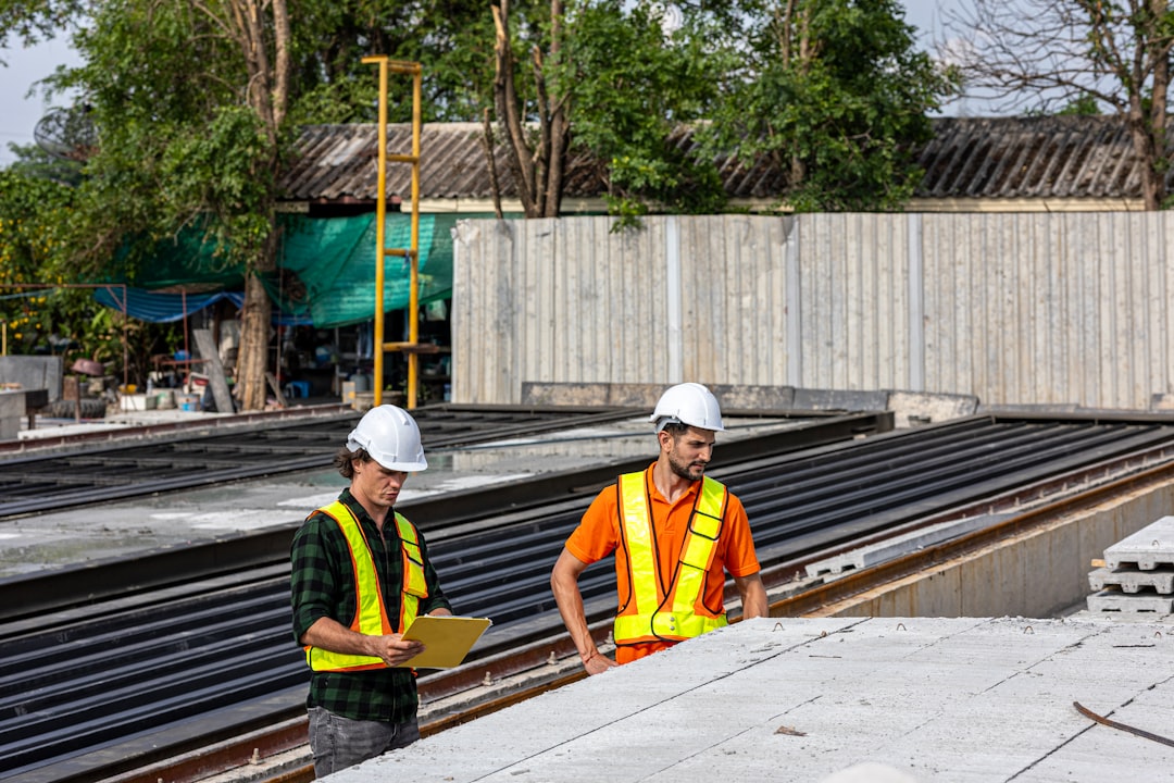 Construction workers review plans at a job site